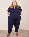 Catie is 5'11" and wearing 5XL Short Sleeve Jumpsuit in Navy Blue