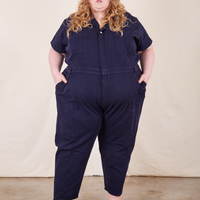 Catie is 5'11" and wearing 5XL Short Sleeve Jumpsuit in Navy Blue