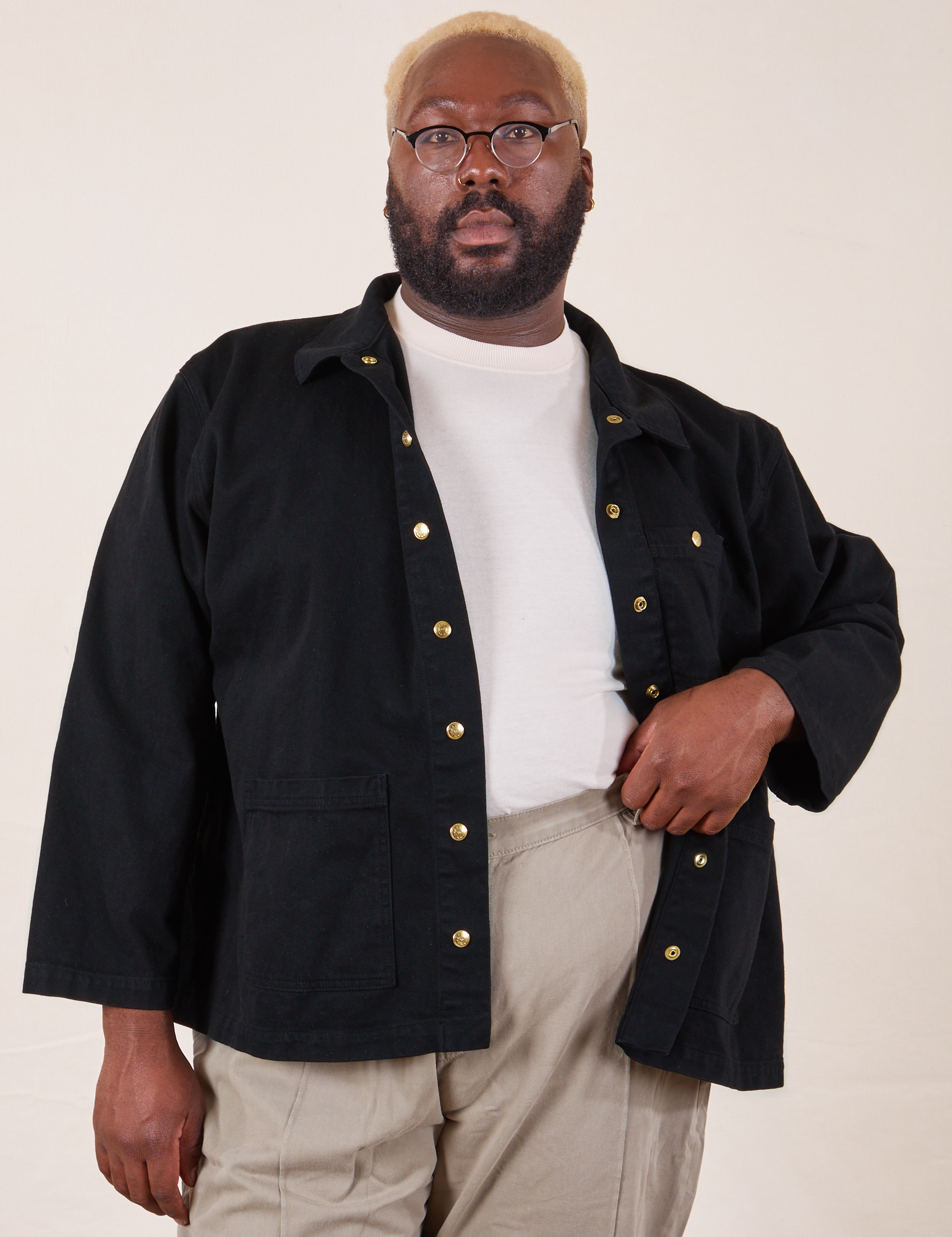 Elijah is wearing Denim Work Jacket in Basic Black with a vintage off-white Tee underneath and khaki grey Western Pants