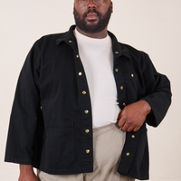 Elijah is wearing Denim Work Jacket in Basic Black with a vintage off-white Tee underneath and khaki grey Western Pants