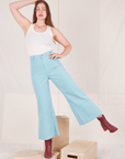 Allison is 5'10" and wearing XS Bell Bottoms in Baby Blue paired with vintage off-white Tank Top
