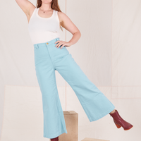 Allison is 5'10" and wearing XS Bell Bottoms in Baby Blue paired with vintage off-white Tank Top