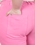 Western Pants in Bubblegum Pink back pocket close up. Worn by Ashley with hand in pocket.