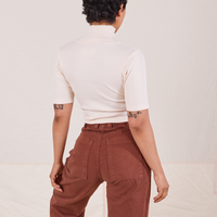 Back view on Mika wearing 1/2 Sleeve Essential Turtleneck in Vintage Off White and fudgesicle brown Bell Bottoms