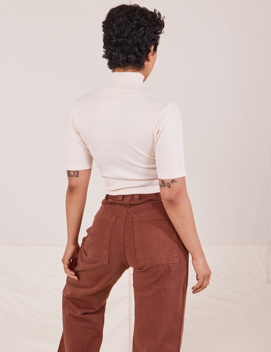 Back view on Mika wearing 1/2 Sleeve Essential Turtleneck in Vintage Off White and fudgesicle brown Bell Bottoms