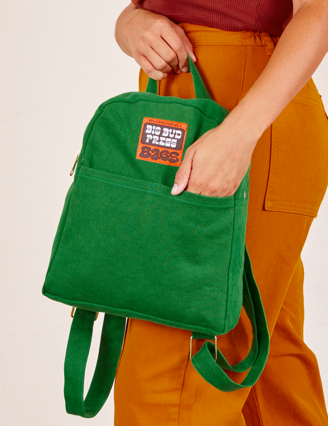 Mini Backpack in Forest Green held by Tiara