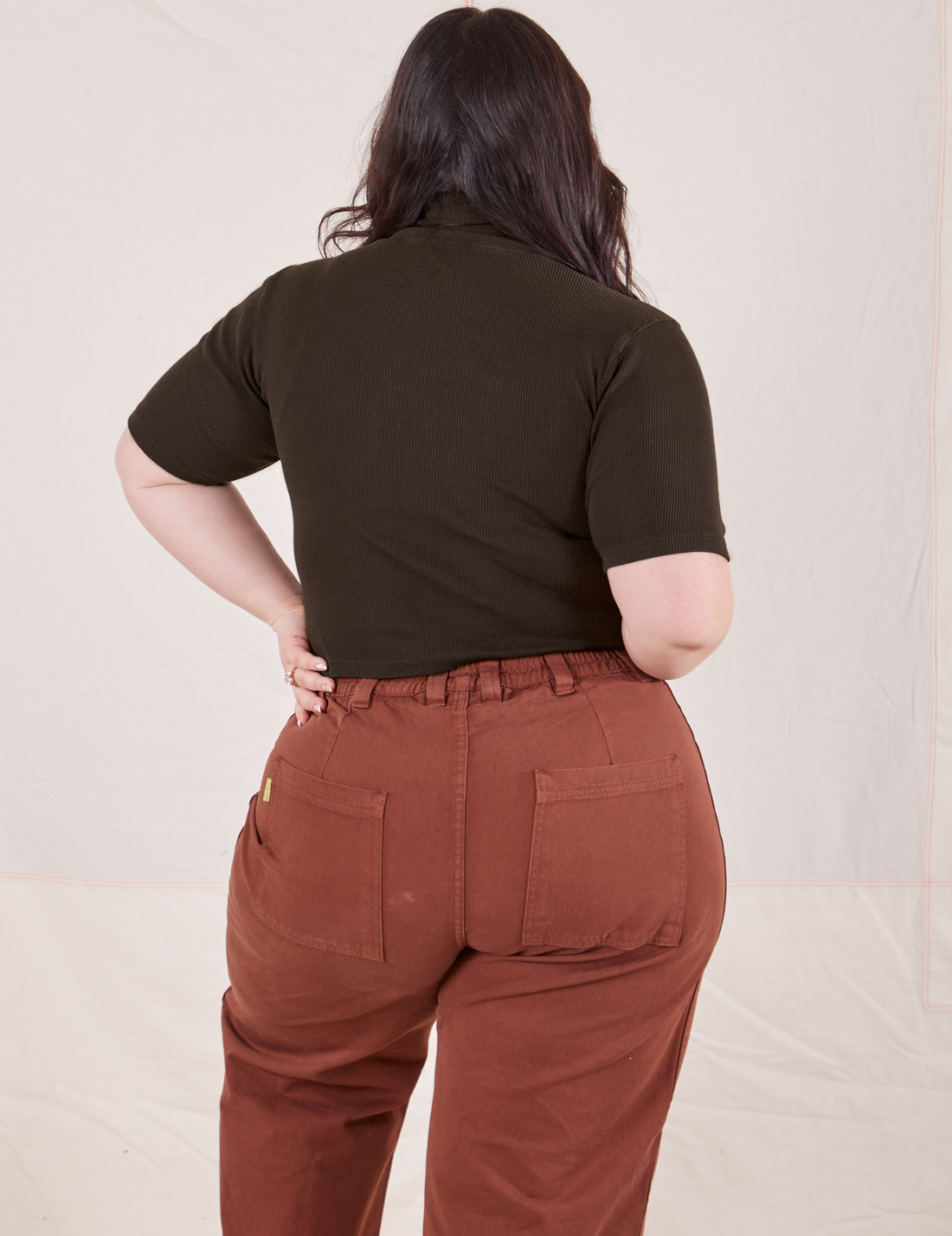Back view of Ashley wearing 1/2 Sleeve Essential Turtleneck in Espresso Brown and fudgesicle brown Bell Bottoms