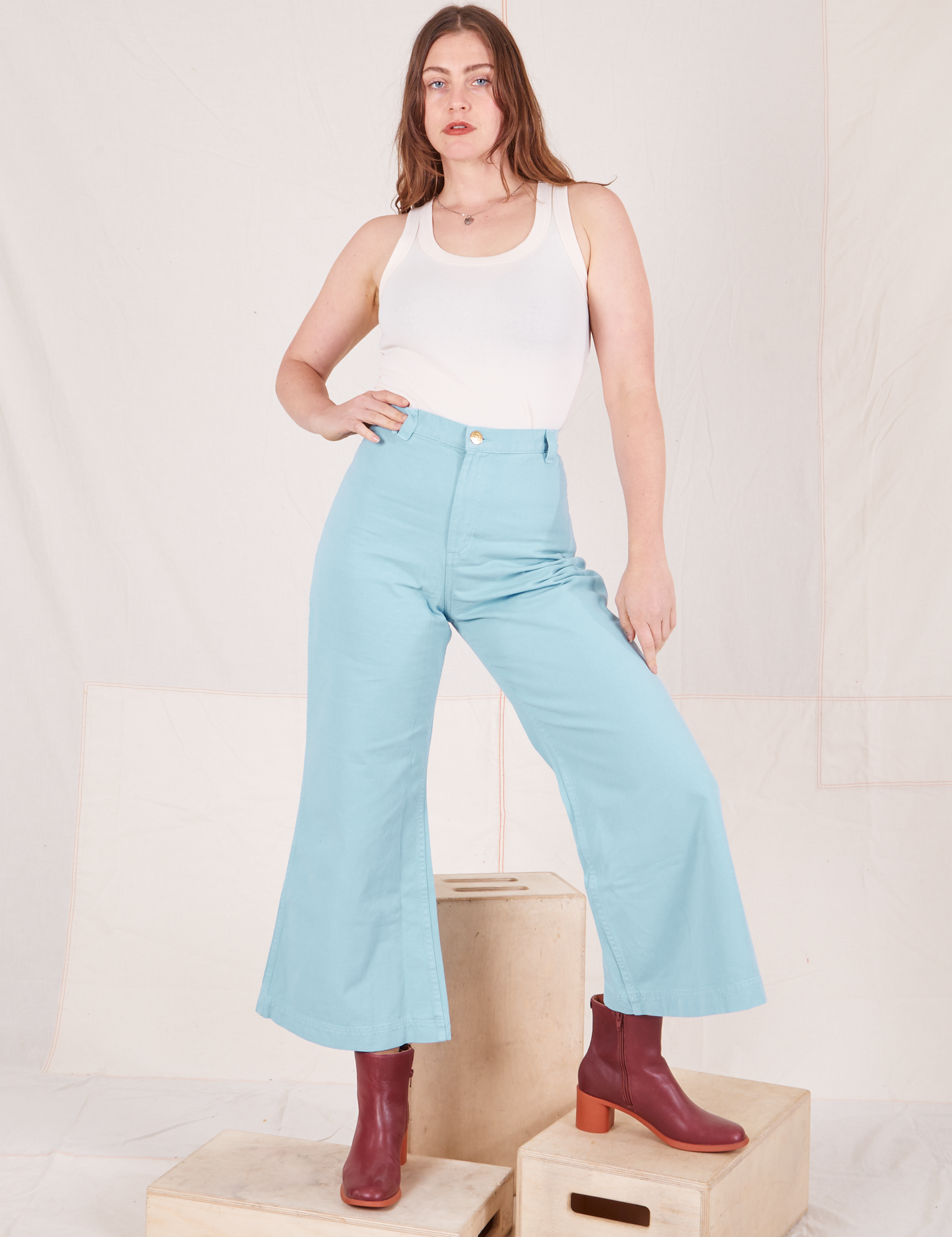 Allison is wearing Bell Bottoms in Baby Blue and vintage off-white Tank Top
