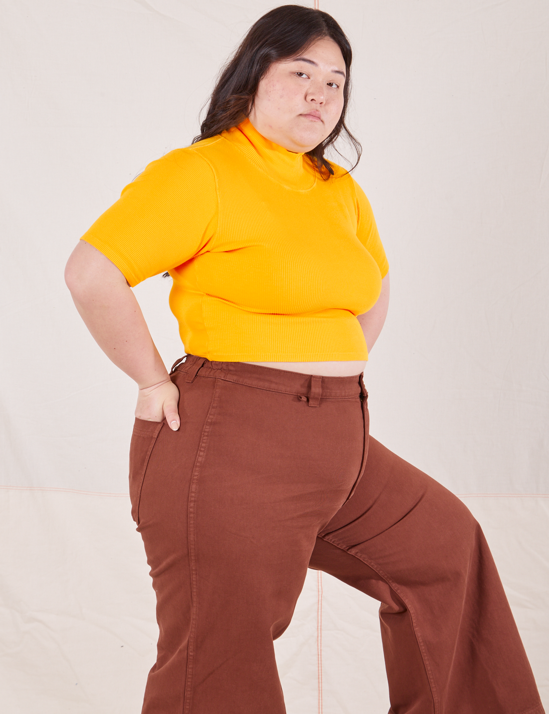 1/2 Sleeve Essential Turtleneck in Sunshine Yellow side view on Ashley wearing fudgesicle brown Bell Bottoms