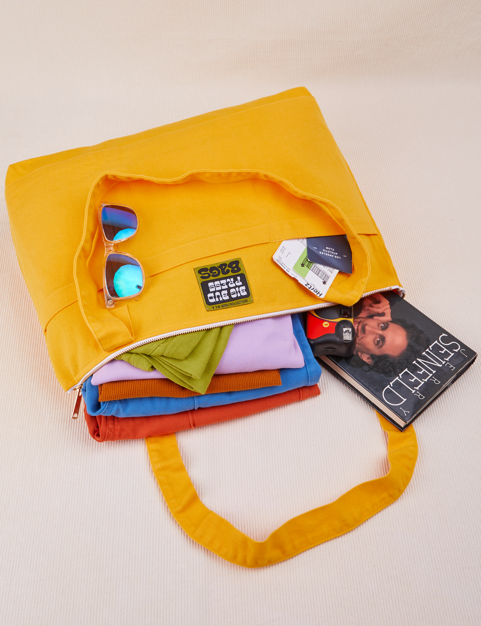 XL Zip Tote in Sunshine Yellow packed with clothing, books, camera