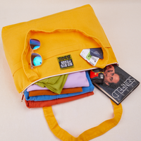 XL Zip Tote in Sunshine Yellow packed with clothing, books, camera