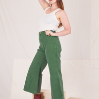 Side view of Bell Bottoms in Dark Emerald Green and vintage off-white Tank Top worn by Allison