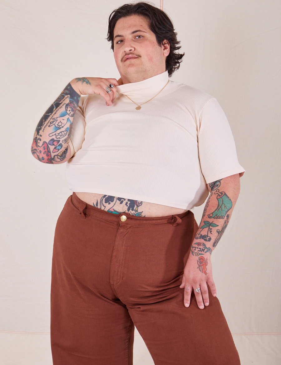 Sam is wearing 1/2 Sleeve Essential Turtleneck in Vintage Off White and fudgesicle brown Bell Bottoms