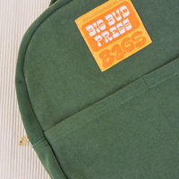 Mini Backpack in Dark Emerald Green with orange and yellow Big Bud press label