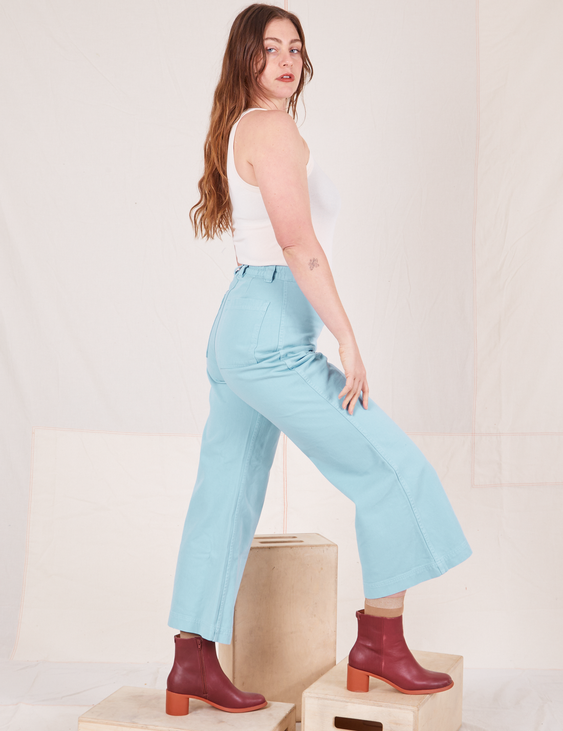 Side view of Bell Bottoms in Baby Blue and vintage off-white Tank Top worn by Allison