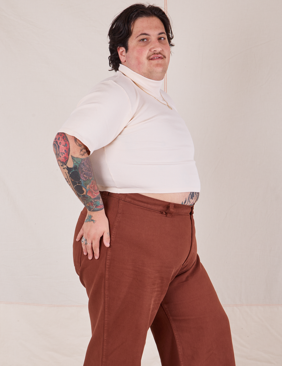 Side view of Sam wearing 1/2 Sleeve Essential Turtleneck in Vintage Off White and fudgesicle brown Bell Bottoms