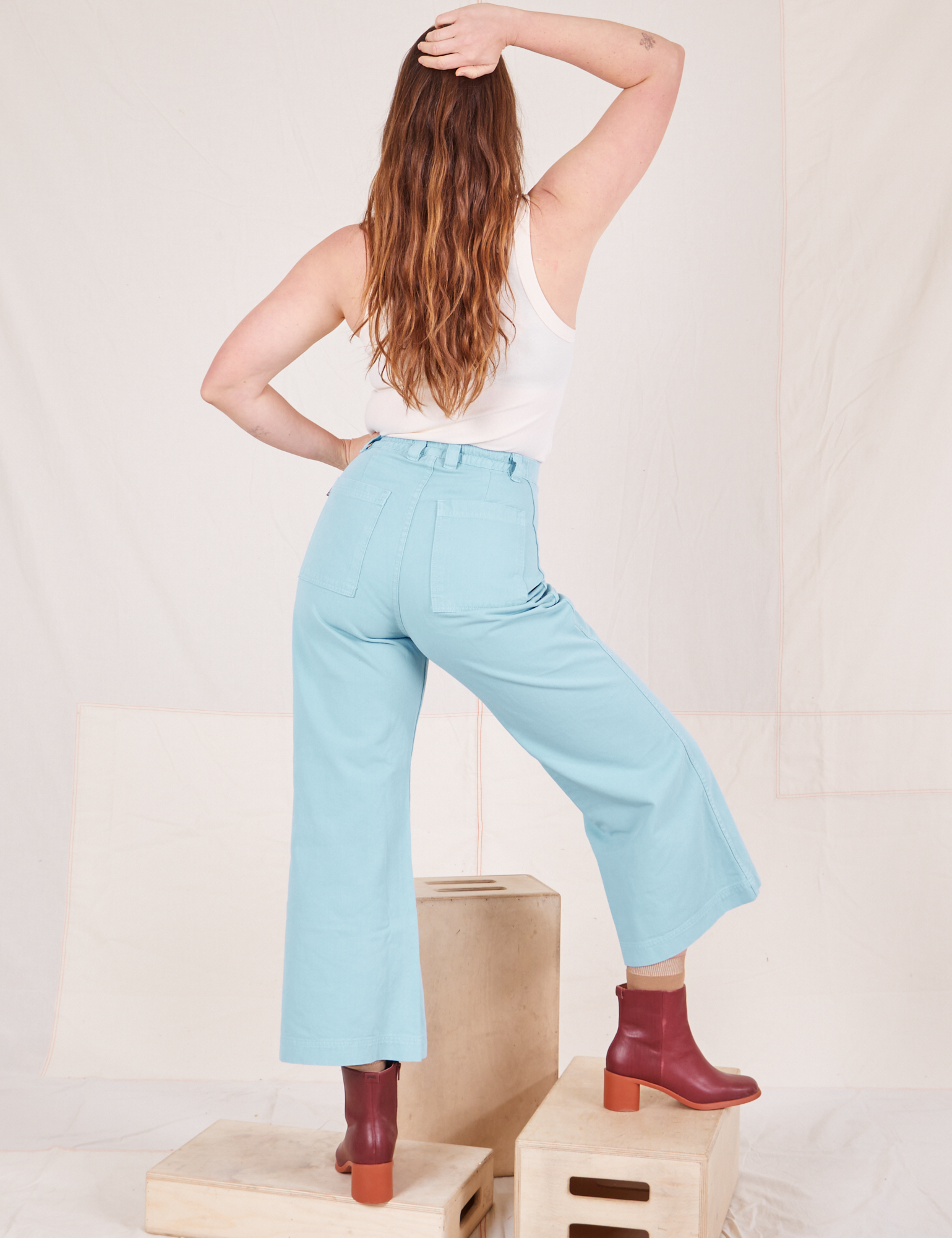 Back view of Bell Bottoms in Baby Blue and vintage off-white Tank Top worn by Allison