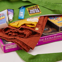 XL Zip Tote in Bright Olive close up packed with clothing and board games
