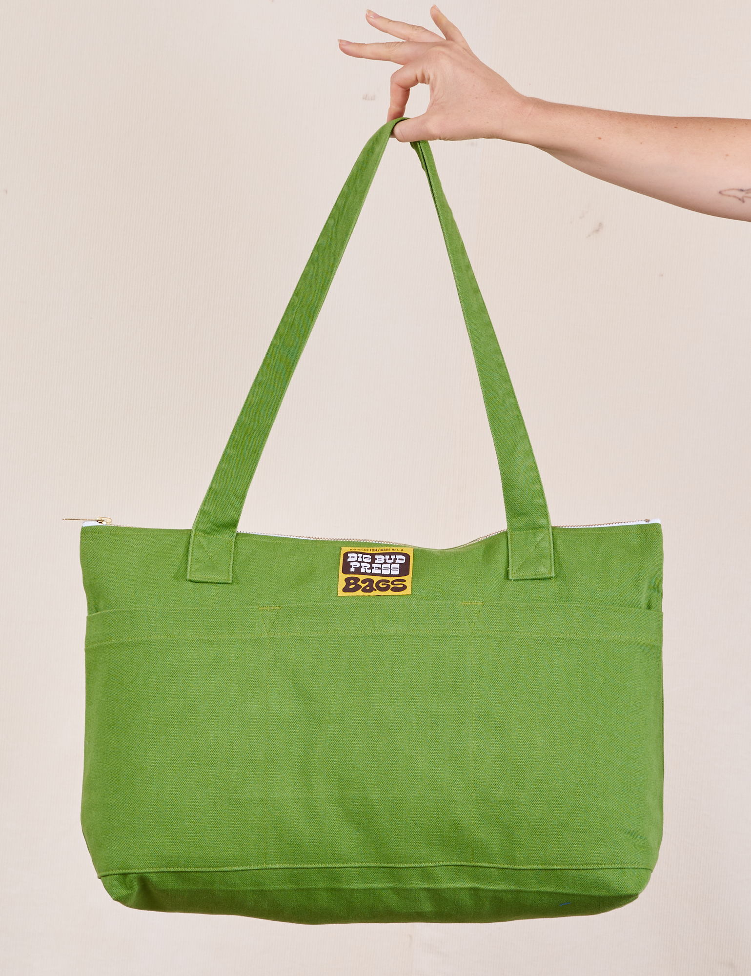 XL Zip Tote in Bright Olive held by model
