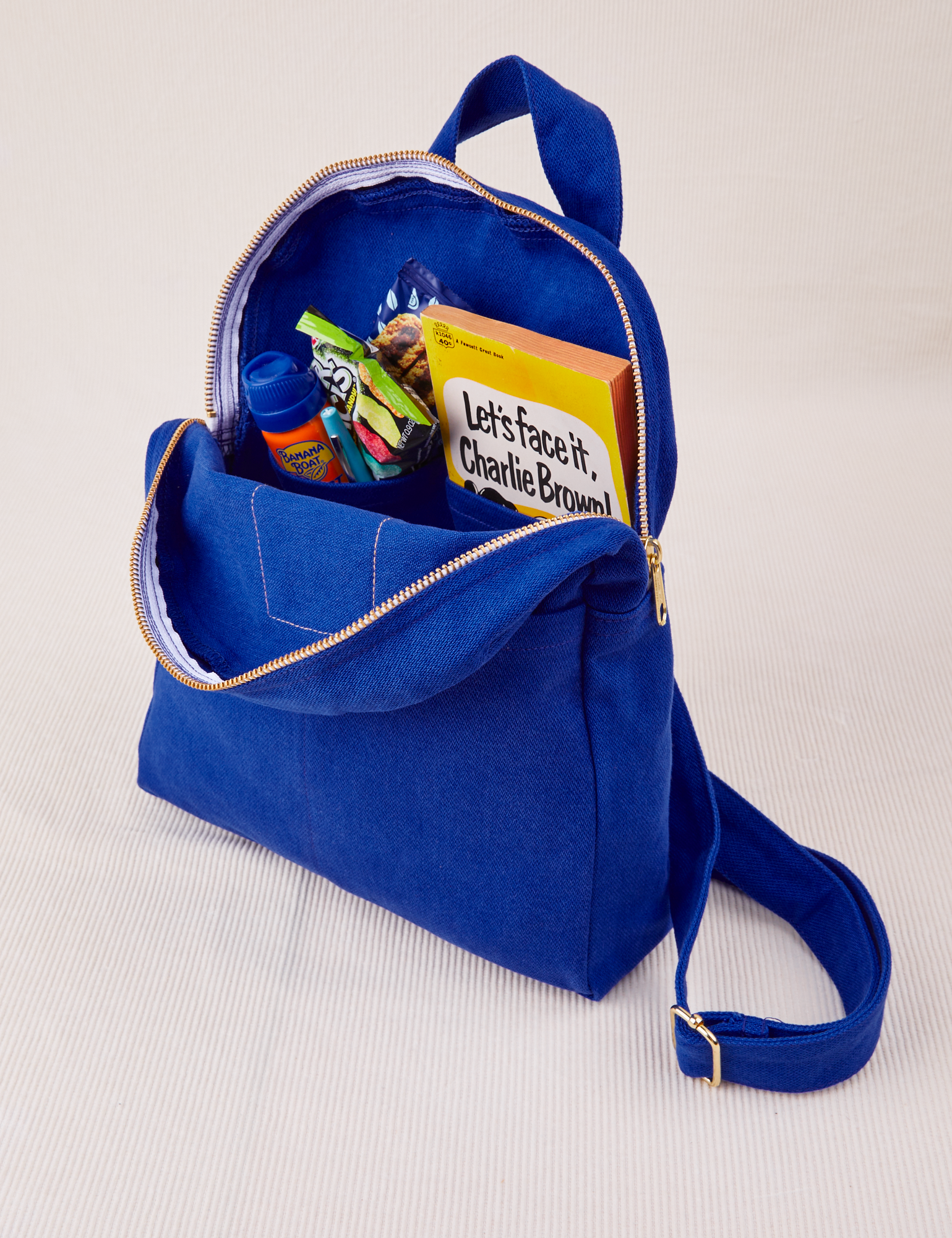 Mini Backpack in Royal Blue open with items in interior pockets