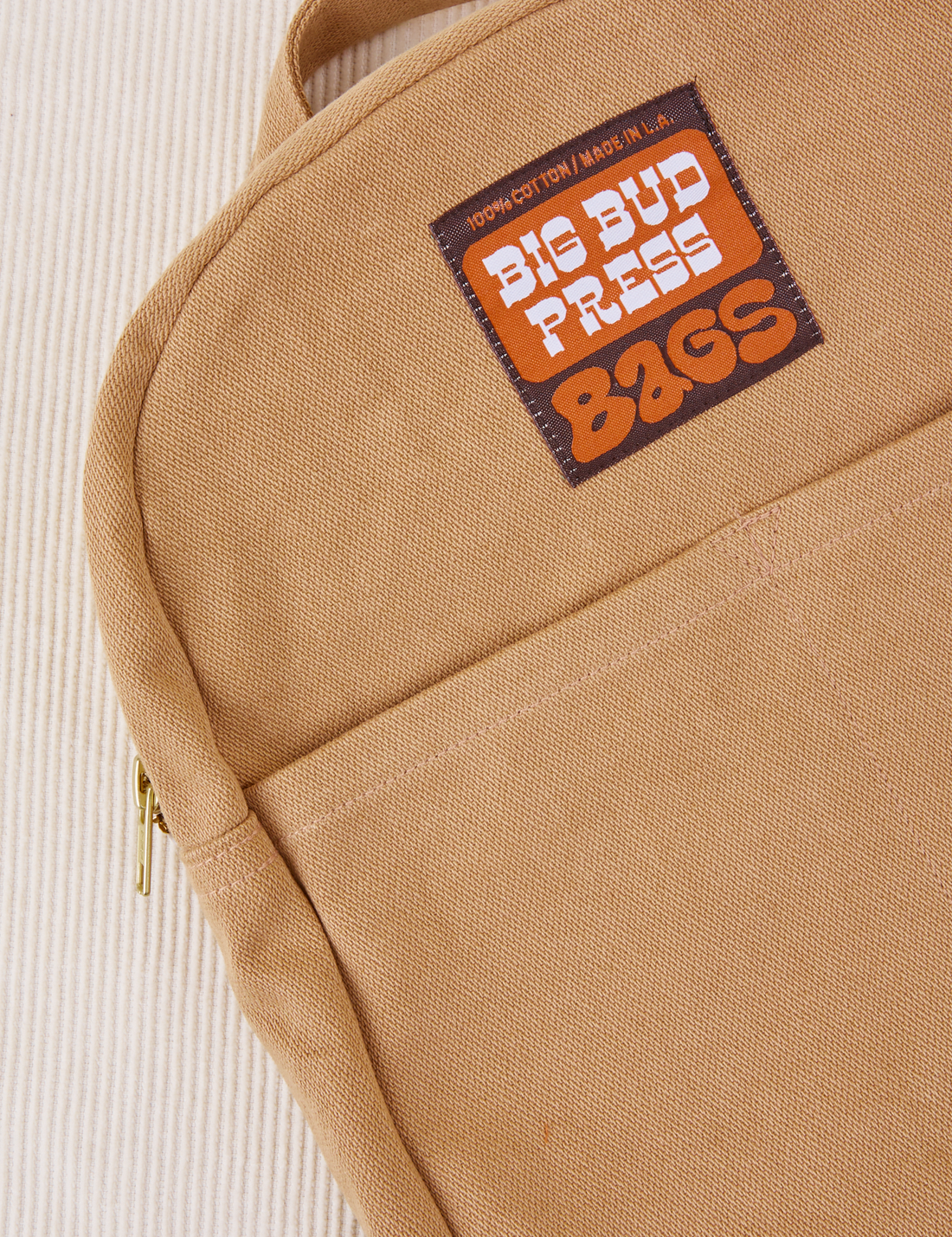 Mini Backpack in Tan close up with brown and orange Big Bud Press label