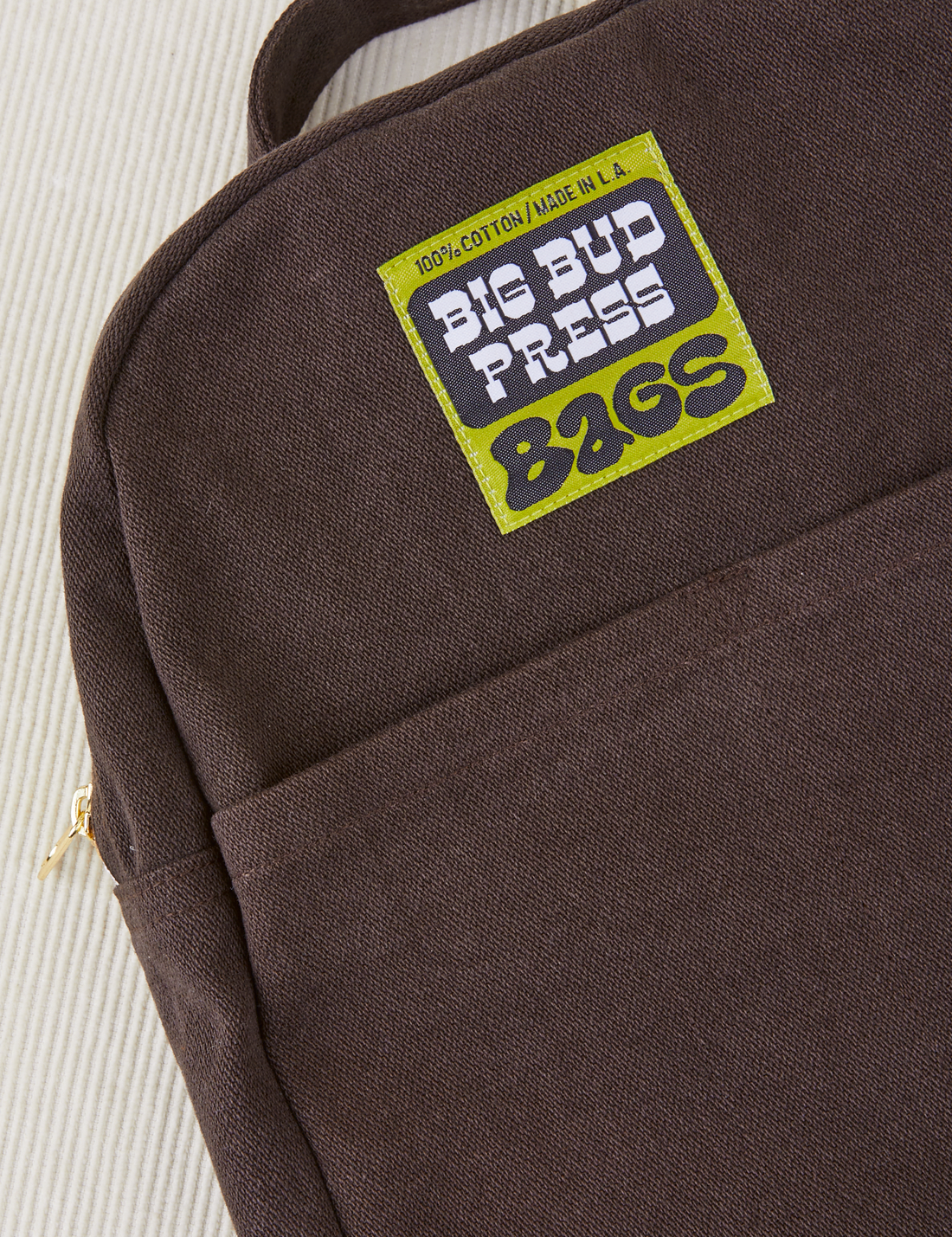 Mini Backpack in Espresso Brown close up with green Big Bud Press label