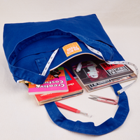 XL Zip Tote in Royal Blue packed with books and magazines