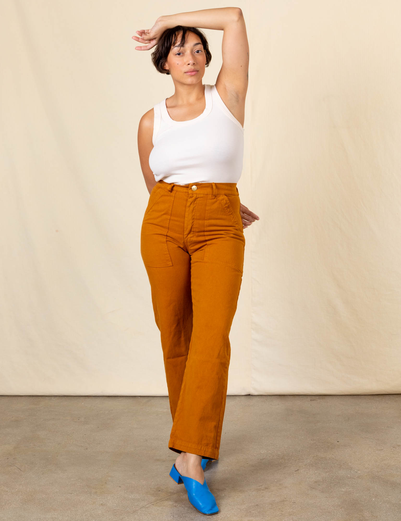 Tiara is 5&#39;4&quot; and wearing S Work Pants in Spicy Mustard paired with vintage off-white Tank Top