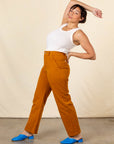 Side view of Work Pants in Spicy Mustard and vintage off-white Tank Top on Tiara