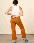 Back view of Work Pants in Spicy Mustard and vintage off-white Tank Top on Tiara