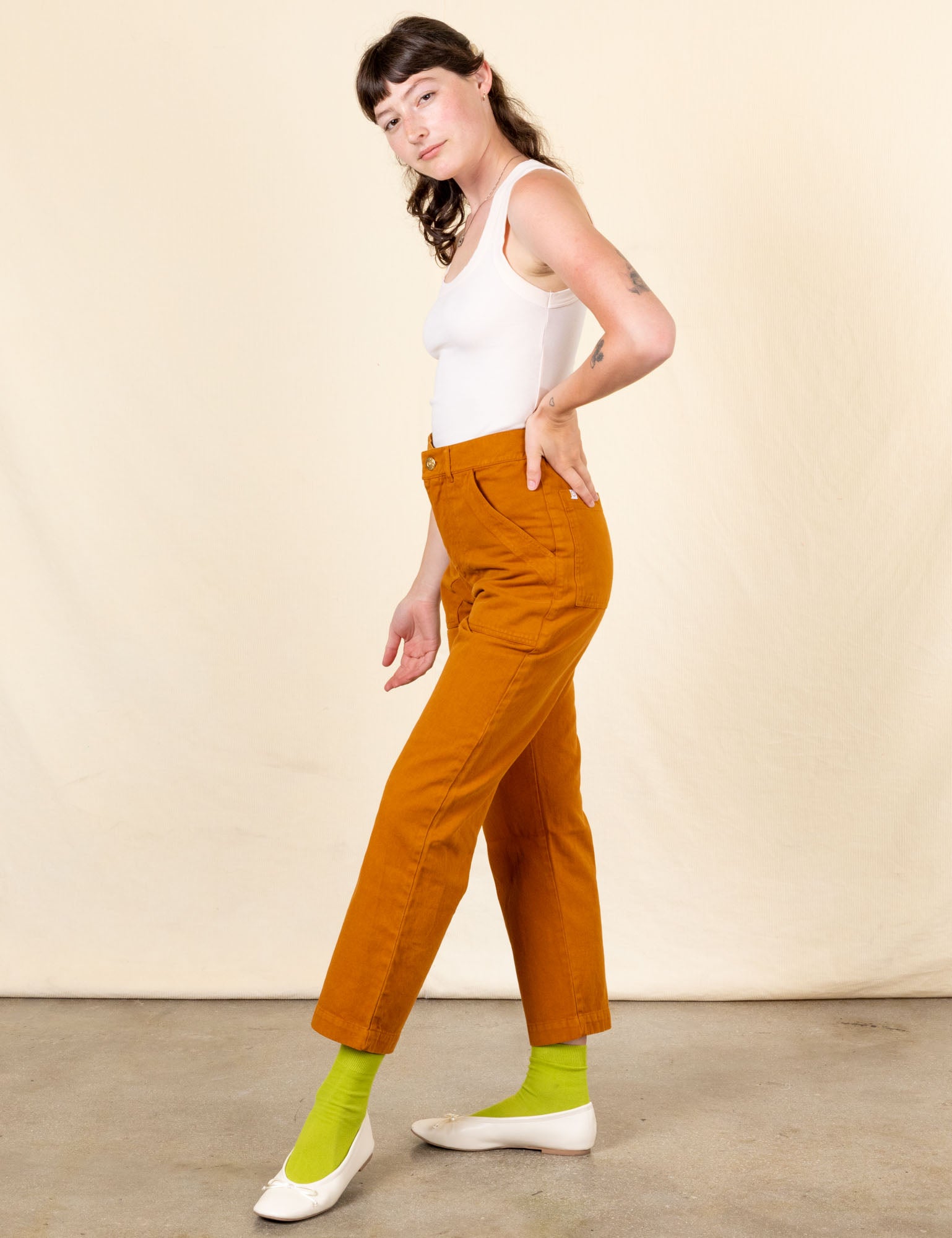 Side view of Work Pants in Spicy Mustard and vintage off-white Tank Top on Alex
