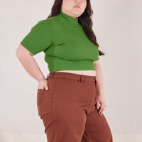 1/2 Sleeve Essential Turtleneck in Bright Olive side view on Ashley wearing fudgesicle brown Bell Bottoms
