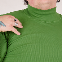 Front close up of 1/2 Sleeve Essential Turtleneck in Bright Olive worn by Sam