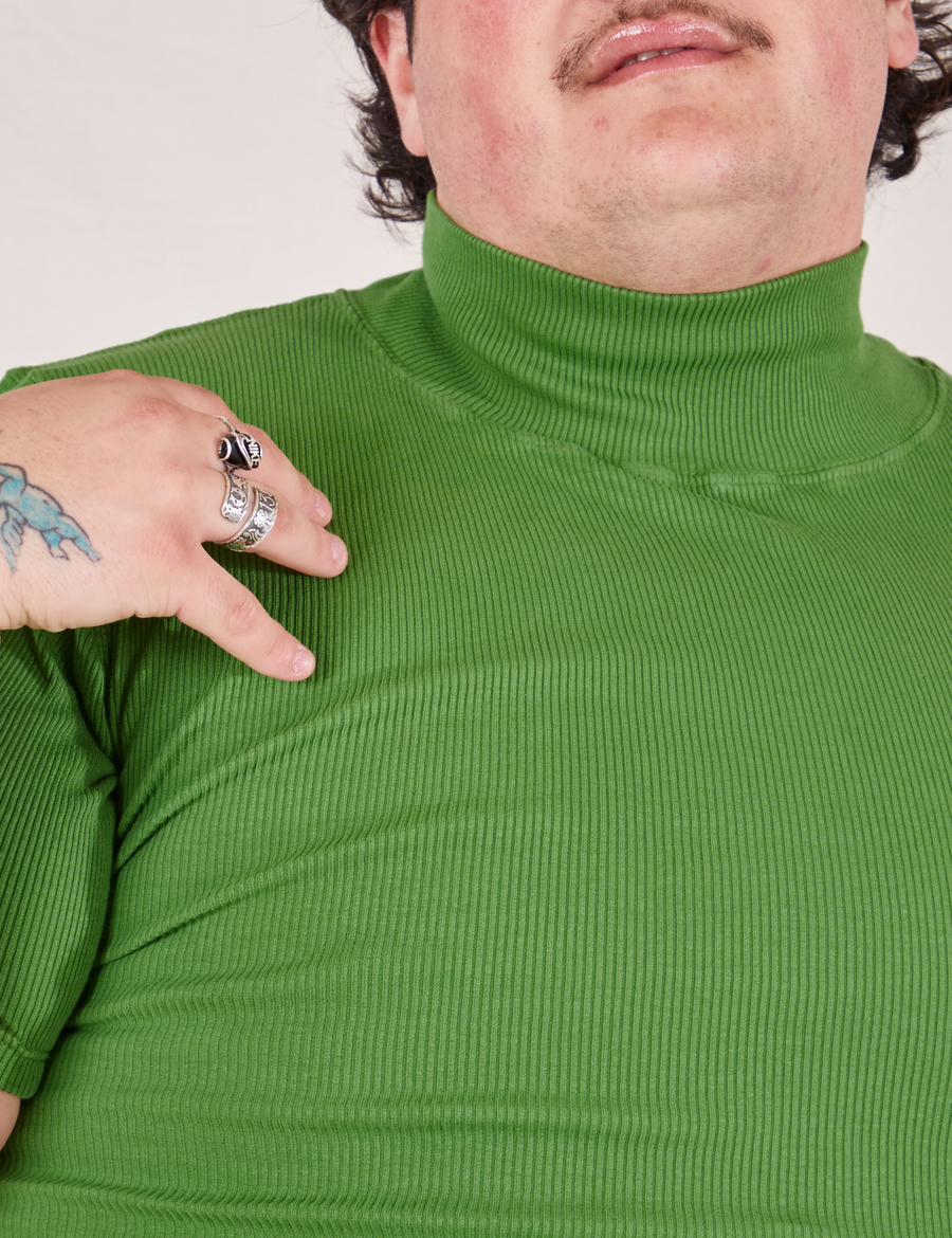 Front close up of 1/2 Sleeve Essential Turtleneck in Bright Olive worn by Sam