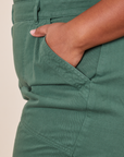 Short Sleeve Jumpsuit in Dark Emerald Green front pant pocket close up on Morgan