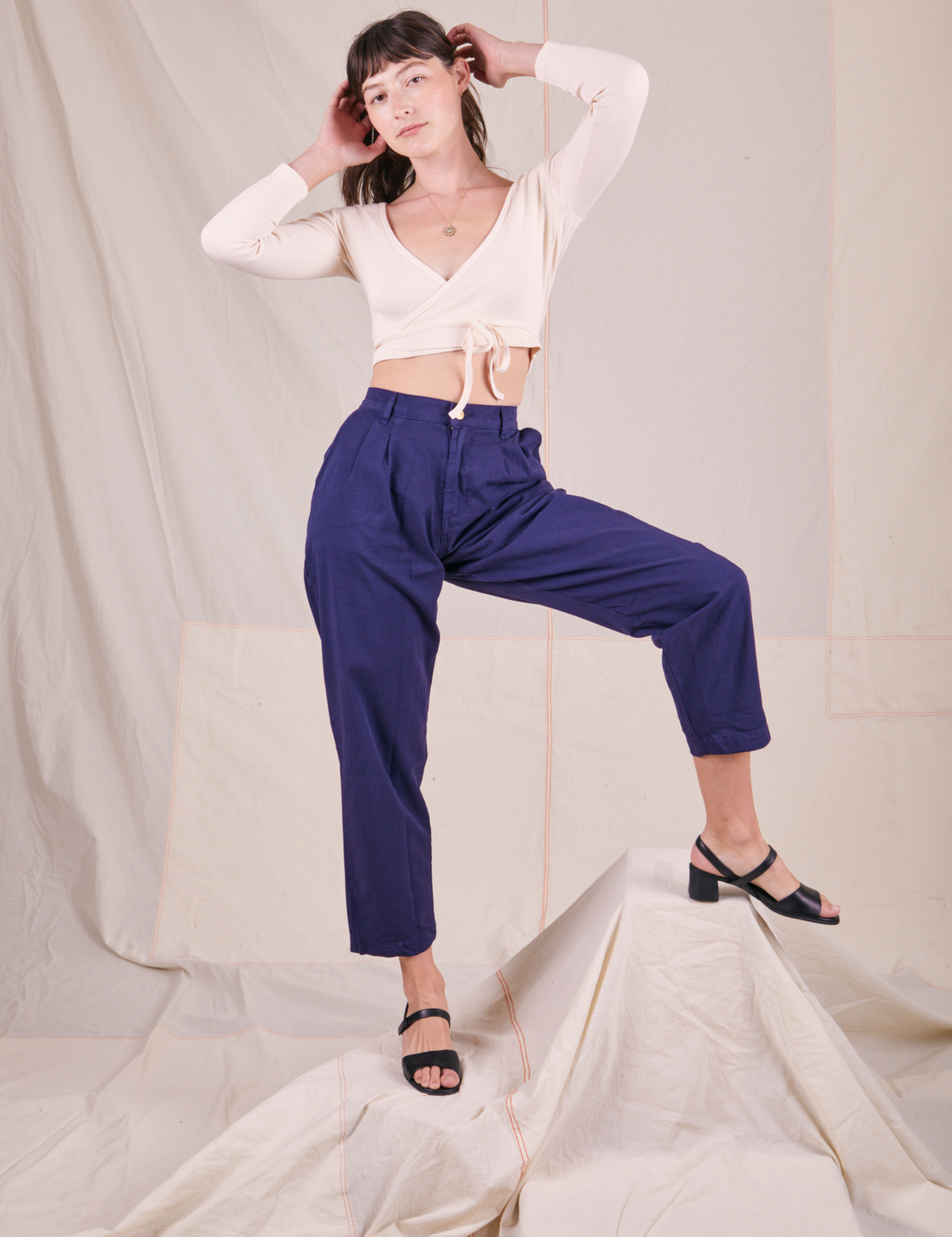 Wrap Top in Vintage Tee Off-White on Alex wearing navy blue trousers