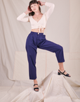Alex is wearing Wrap Top in Vintage Tee Off-White and trouser pants