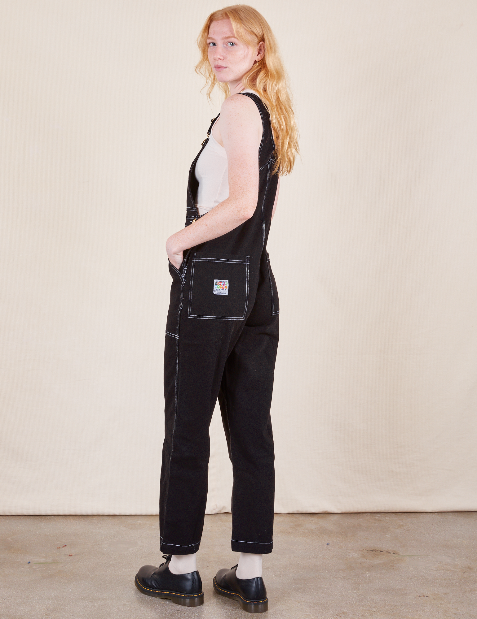 Angled back view of Original Overalls in Basic Black worn by Margaret.