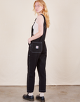 Angled back view of Original Overalls in Basic Black worn by Margaret.