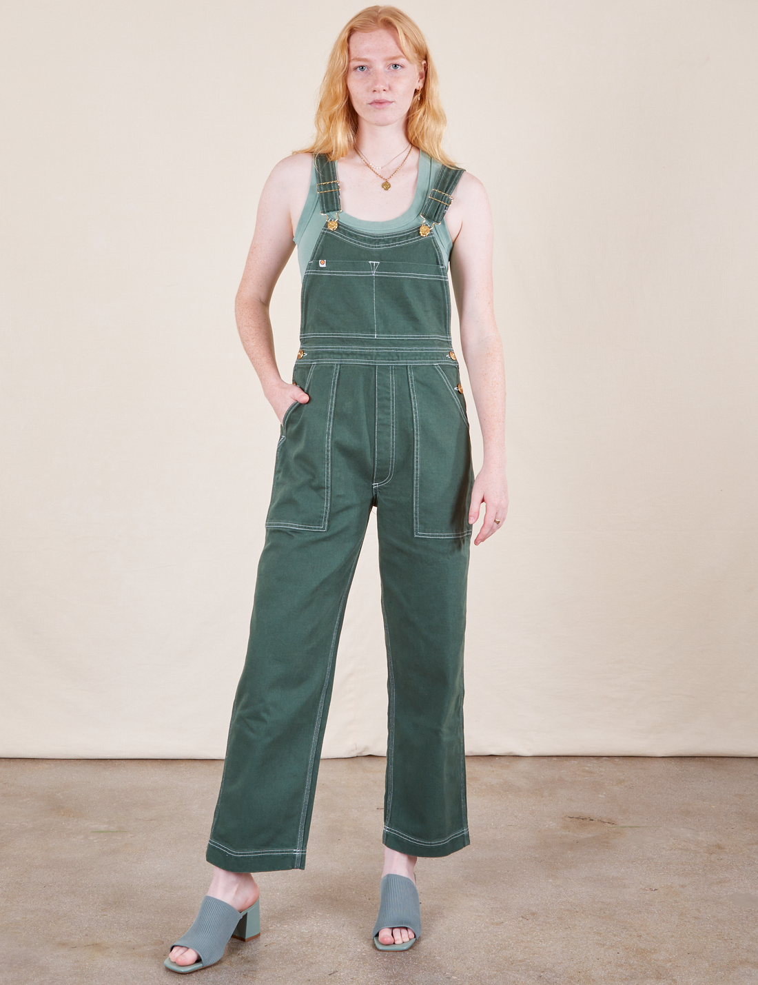 Margaret is 5'11" and wearing XXS Original Overalls in Dark Emerald Green