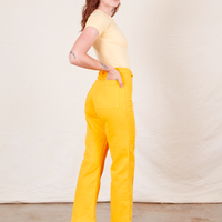 Western Pants in Sunshine Yellow side view on Alex wearing butter yellow Baby Tee