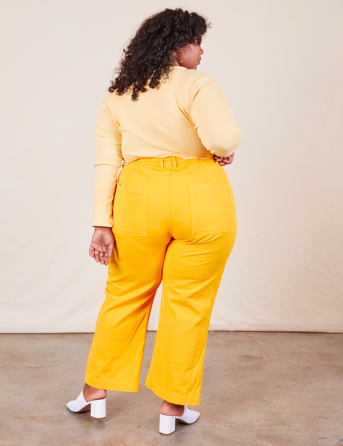 Western Pants in Sunshine Yellow back view on Morgan wearing butter yellow Long Sleeve V-Neck Tee