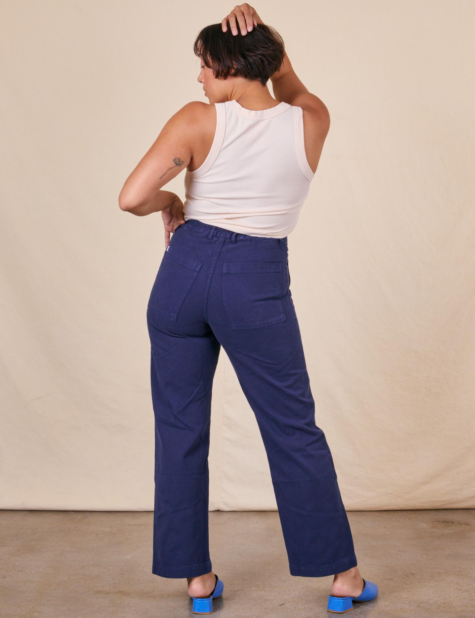 Back view of Work Pants in Navy Blue and vintage off-white Tank Top on Tiara