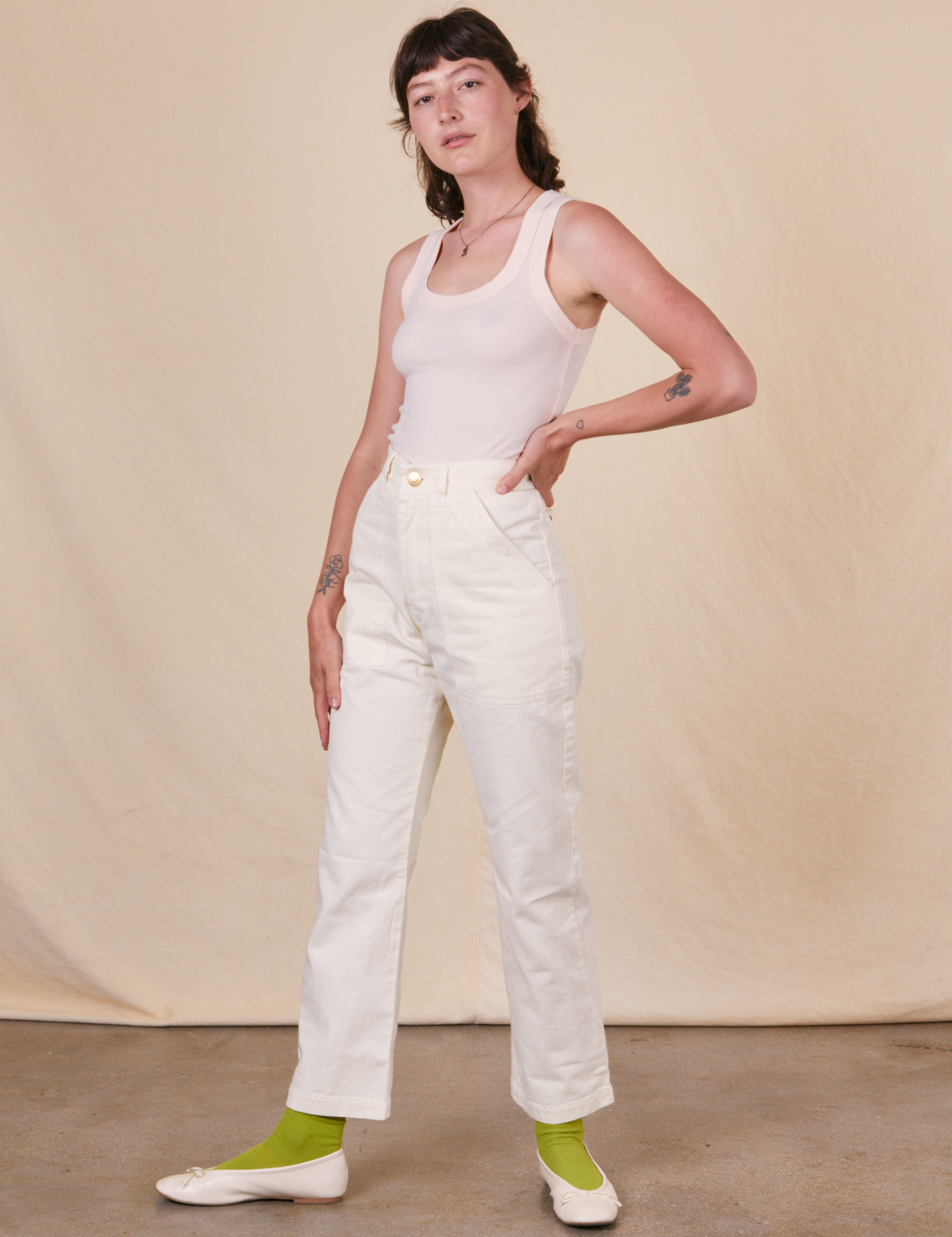 Alex is 5&#39;8&quot; and wearing XS Work Pants in Vintage Tee Off-White paired with a Tank Top