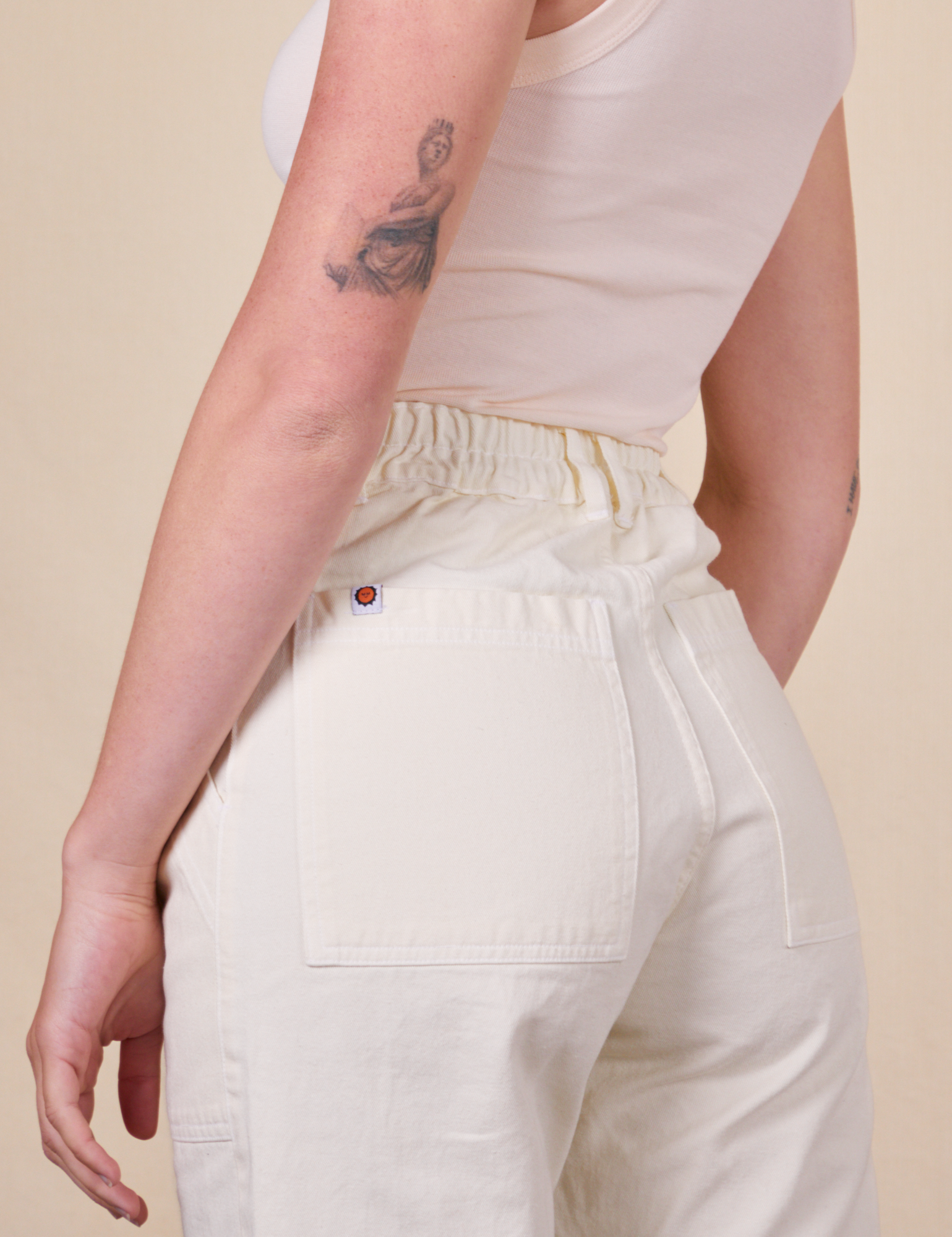 Work Pants in Vintage Tee Off-White back pocket close up on Alex