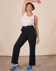 Tiara is 5'4" and wearing S Work Pants in Basic Black paired with a vintage off-white Tank Top