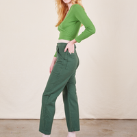 Work Pants in Dark Emerald Green side view on Margaret wearing bright olive Wrap Top