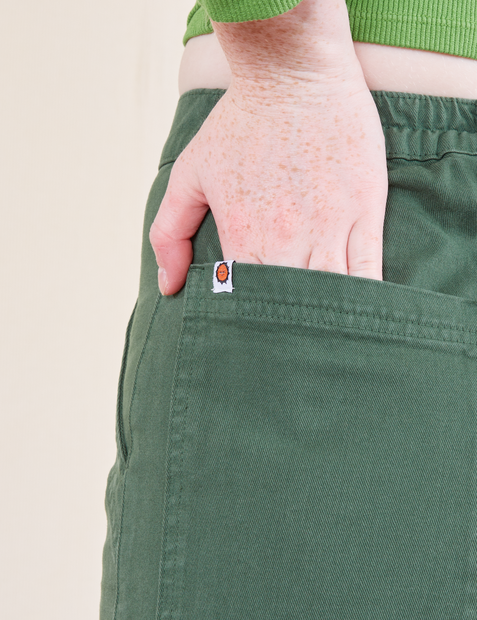 Work Pants in Dark Emerald Green back pocket close up on Margaret