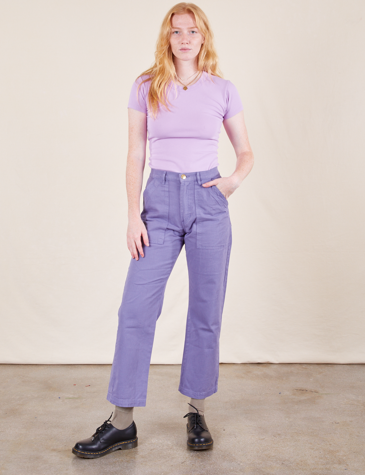 Margaret is 5&#39;11&quot; and wearing XXS Work Pants in Faded Grape and a Baby Tee