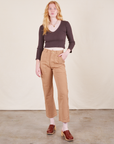 Margaret is 5'11" and wearing XXS Work Pants in Tan paired with espresso brown Long Sleeve V-Neck Tee